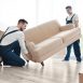 bigstock-Delivery-men-moving-sofa-in-ro-219881854-min